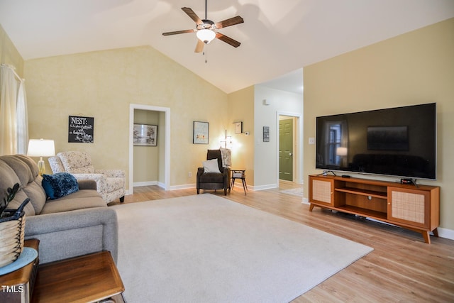 living area featuring light wood-style floors, lofted ceiling, baseboards, and a ceiling fan