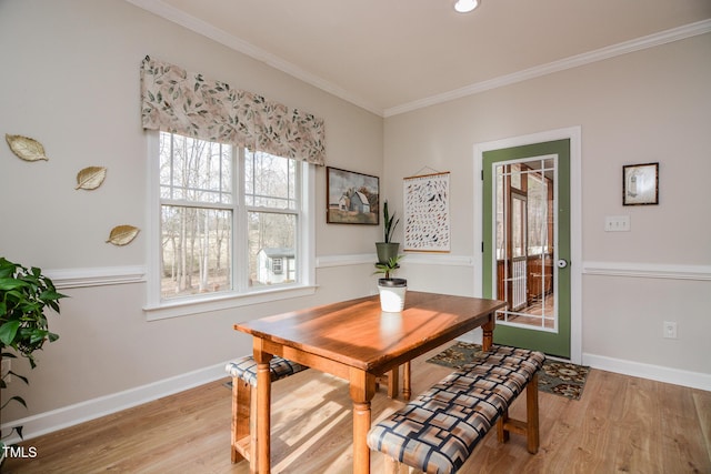 dining area featuring ornamental molding, wood finished floors, and baseboards