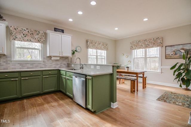 kitchen featuring tasteful backsplash, white cabinets, a sink, green cabinetry, and dishwasher