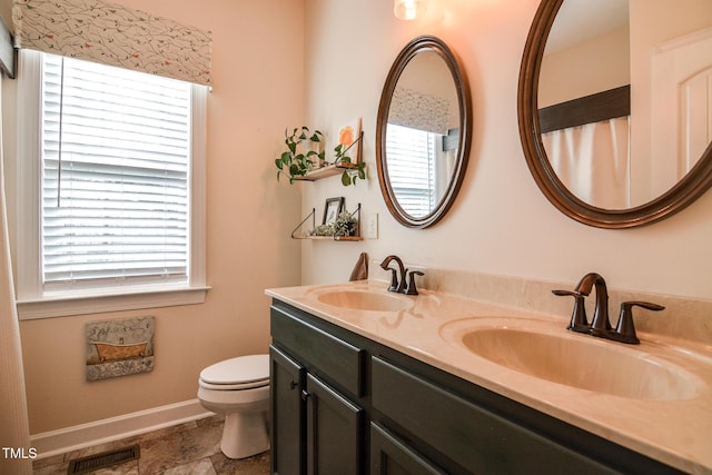 full bathroom with plenty of natural light, a sink, and visible vents