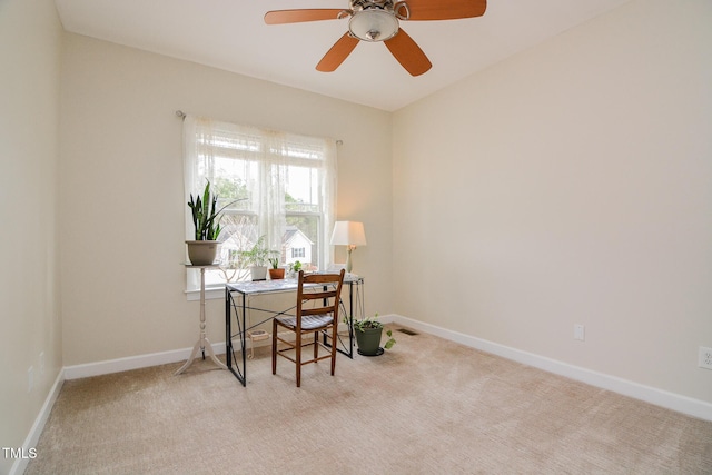 carpeted home office featuring visible vents, baseboards, and a ceiling fan