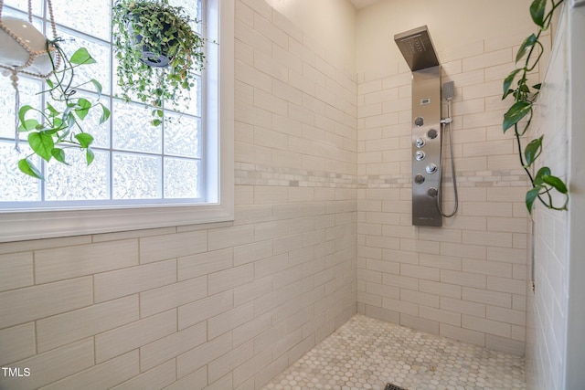 bathroom with a tile shower