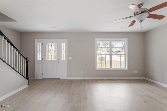 entrance foyer featuring stairs, light wood-style flooring, visible vents, and baseboards