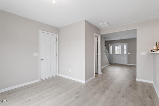 interior space featuring baseboards, stairs, and light wood-style floors