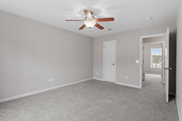 unfurnished bedroom featuring visible vents, baseboards, a ceiling fan, and carpet flooring