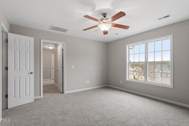 unfurnished bedroom with visible vents, ceiling fan, baseboards, and carpet