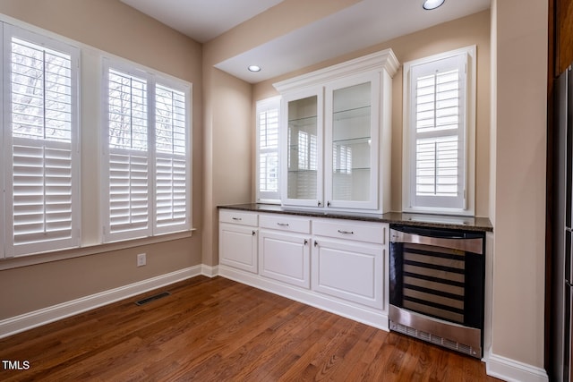 bar featuring beverage cooler, visible vents, baseboards, dark wood-style floors, and recessed lighting