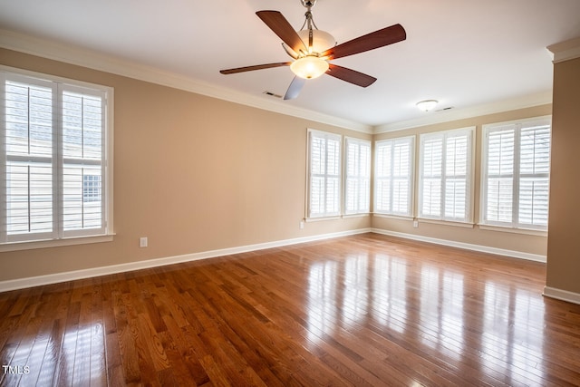 empty room featuring hardwood / wood-style flooring, plenty of natural light, and crown molding