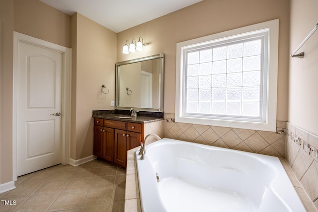 full bathroom featuring tile patterned flooring, a garden tub, and vanity