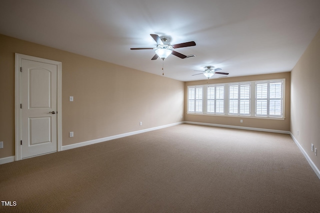 spare room with light carpet and baseboards