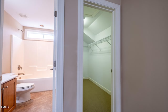 full bath featuring toilet, vanity, visible vents, a spacious closet, and shower / bathing tub combination