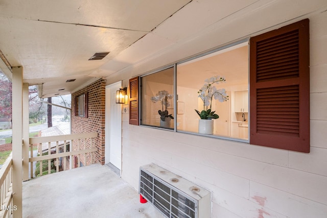 view of patio featuring covered porch and visible vents