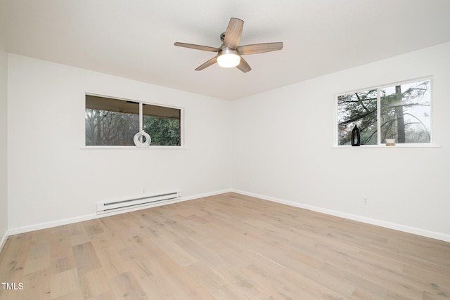 unfurnished room with a baseboard heating unit, ceiling fan, light wood-type flooring, and baseboards