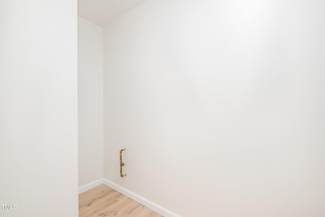 washroom with light wood finished floors and baseboards