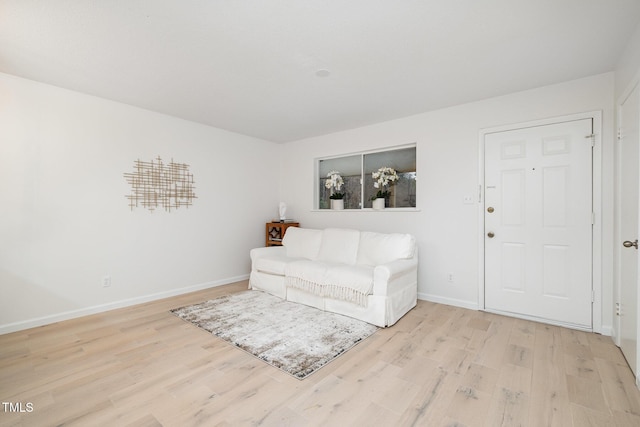 living room with light wood finished floors and baseboards