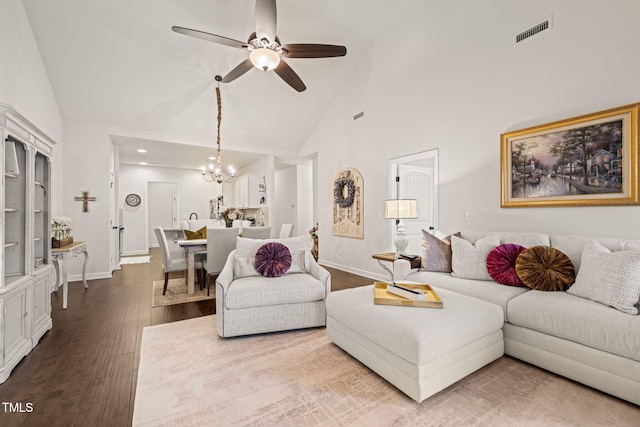 living room with high vaulted ceiling, a chandelier, wood finished floors, ceiling fan, and baseboards