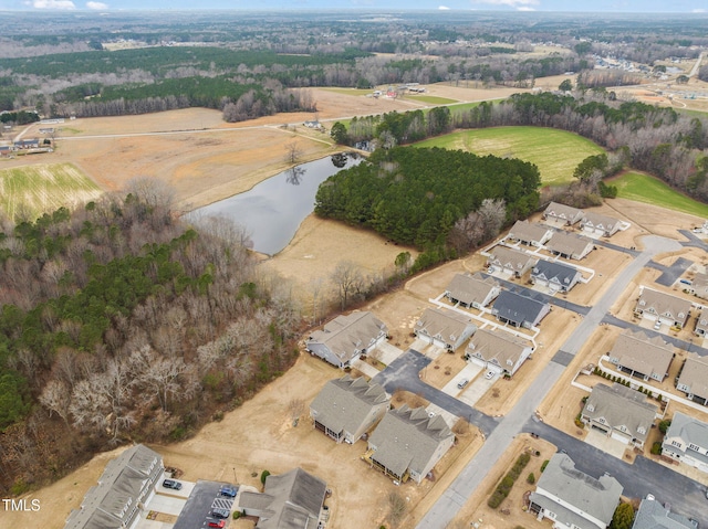 aerial view of property and surrounding area featuring a nearby body of water and nearby suburban area