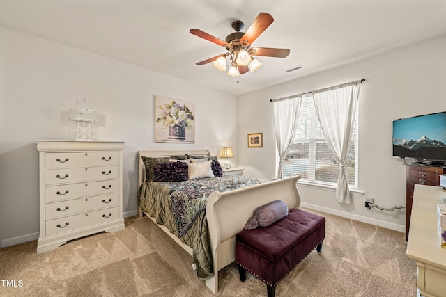 carpeted bedroom featuring baseboards and a ceiling fan