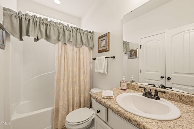 bathroom with toilet, vanity, and shower / bath combo with shower curtain