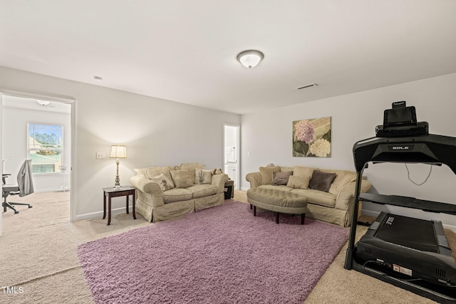 carpeted living room featuring baseboards