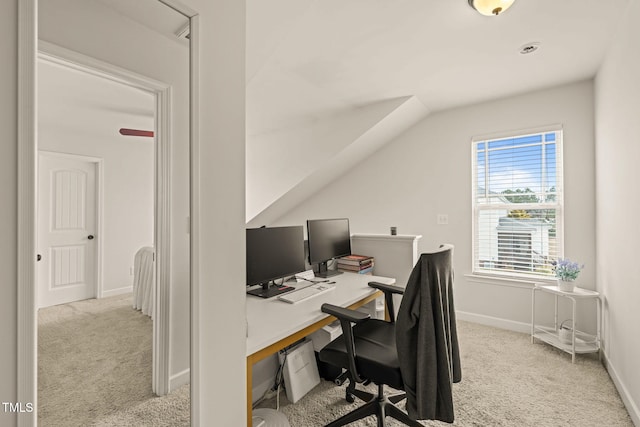 carpeted office space with baseboards and vaulted ceiling