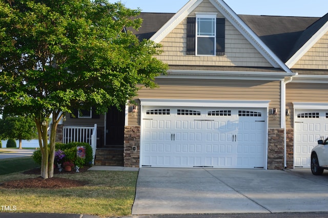 craftsman house with stone siding, concrete driveway, and an attached garage