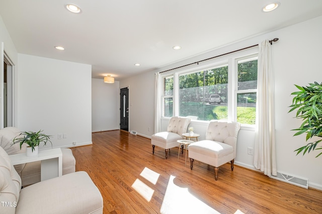 interior space with light wood-style floors, recessed lighting, visible vents, and baseboards