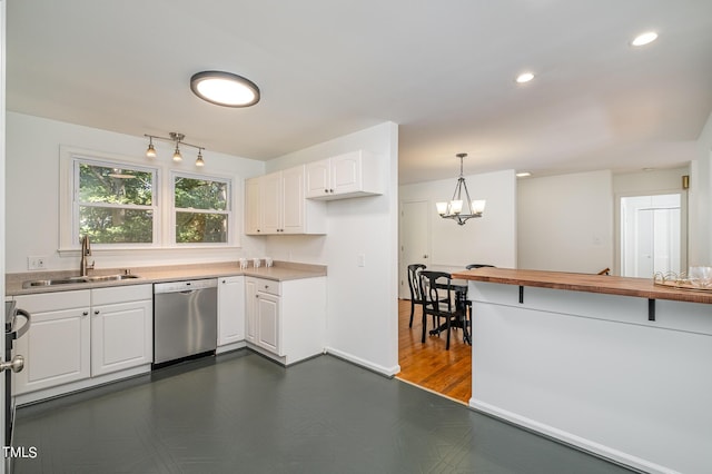 kitchen with pendant lighting, white cabinets, dishwasher, and a sink