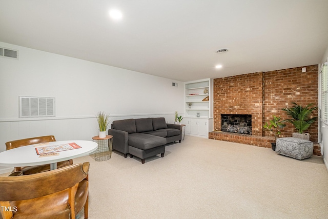 living area with carpet floors, a fireplace, visible vents, and built in features