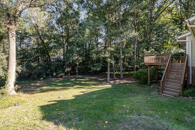 view of yard with stairway and a wooden deck