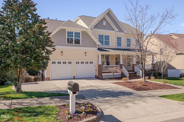 view of front of home featuring a porch, concrete driveway, and a garage