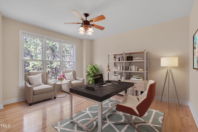 office space featuring ceiling fan, baseboards, and wood finished floors