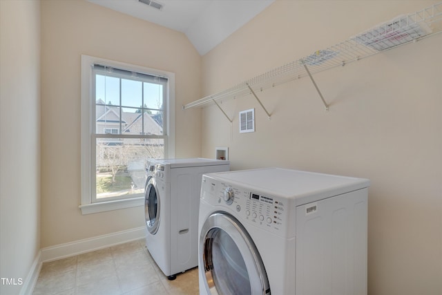 laundry room featuring washer and dryer, visible vents, baseboards, and laundry area