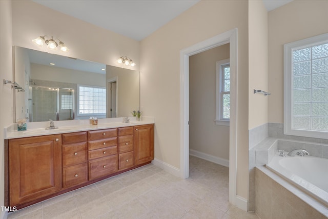 bathroom with a shower stall, tile patterned floors, baseboards, double vanity, and a bath