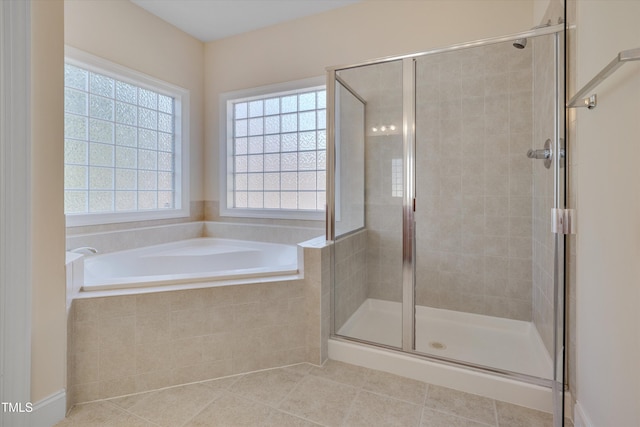 full bath featuring a garden tub, a shower stall, and tile patterned flooring