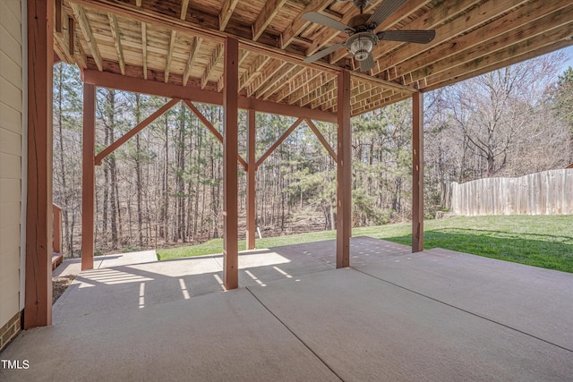 view of patio with ceiling fan and fence