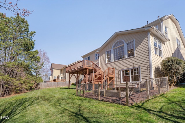 back of property featuring a lawn, stairs, a deck, and fence