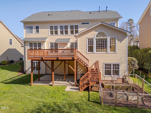 back of house featuring stairs, a lawn, a deck, a garden, and a patio