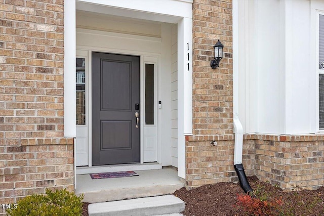 entrance to property with brick siding