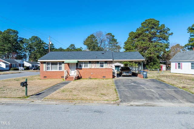 ranch-style house with aphalt driveway, a carport, a front yard, crawl space, and brick siding