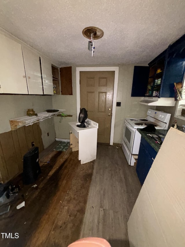 kitchen featuring dark wood-type flooring, electric range, a textured ceiling, and open shelves