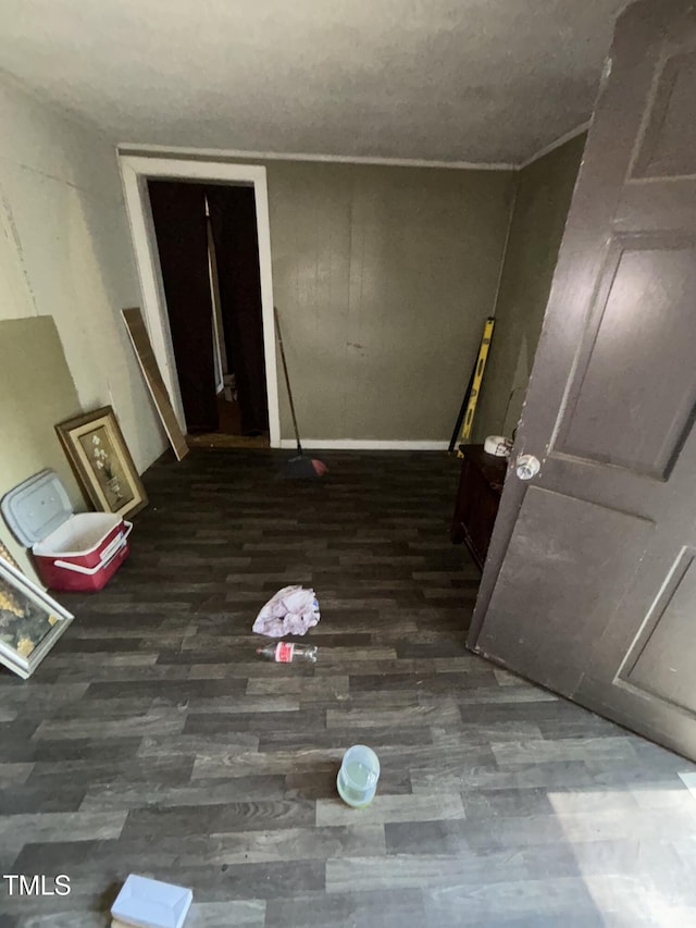 interior space with baseboards and wood finished floors