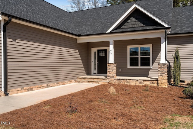 view of front of house featuring covered porch and roof with shingles