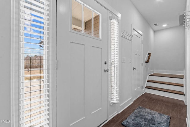 foyer featuring baseboards, visible vents, dark wood-style flooring, stairs, and recessed lighting