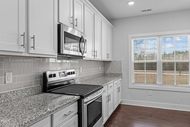 kitchen featuring visible vents, white cabinets, baseboards, dark wood-style flooring, and stainless steel appliances