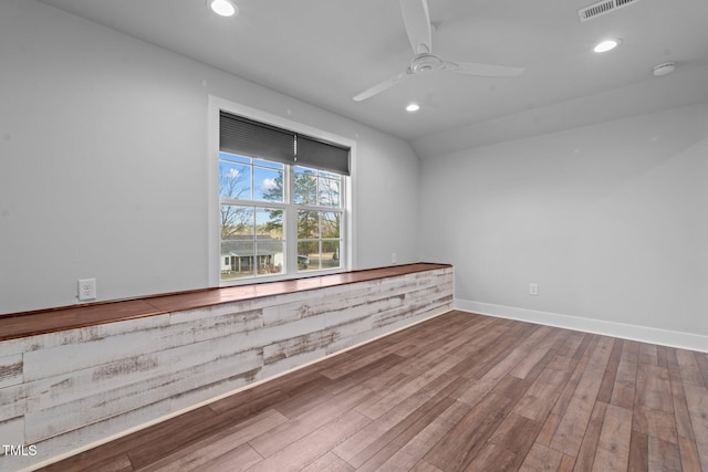 empty room featuring recessed lighting, visible vents, a ceiling fan, wood finished floors, and baseboards