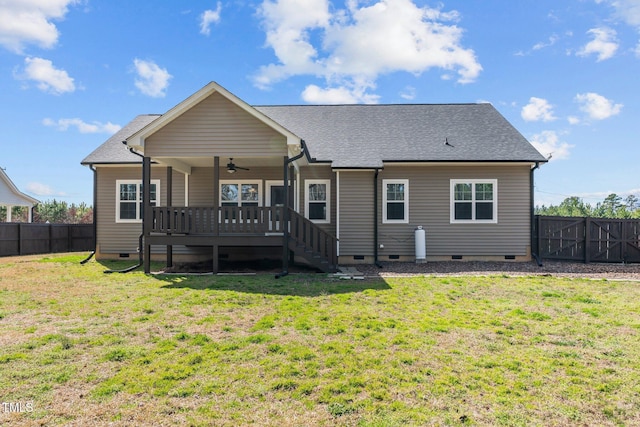 rear view of property featuring a shingled roof, ceiling fan, a fenced backyard, crawl space, and a yard