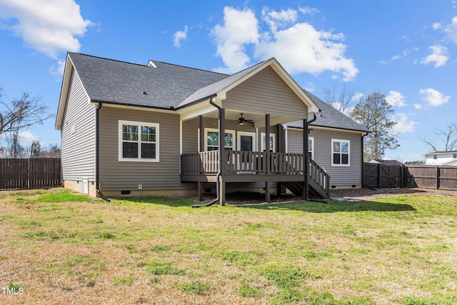 back of house with a lawn, crawl space, a fenced backyard, and a ceiling fan