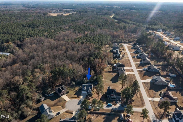 aerial view featuring a forest view and a residential view