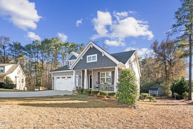 view of front of property with concrete driveway, a porch, and an attached garage